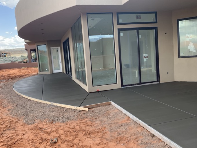 A curved patio wrapping a custom home