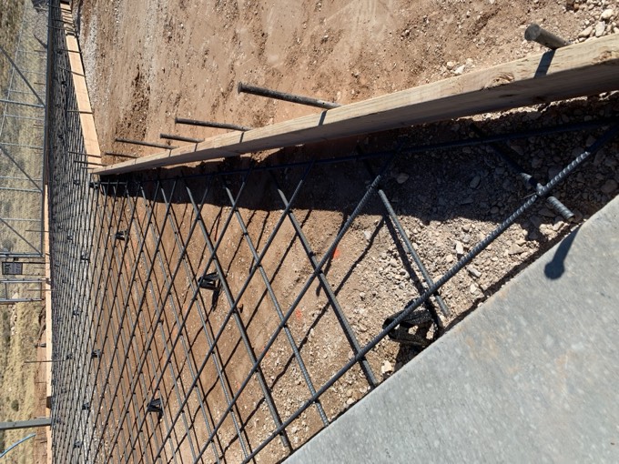 Rebar grid tied and ready over a compacted pad