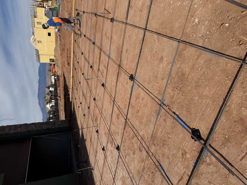 Rebar tied over a compacted foundation pad